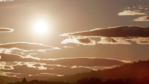 Low Sun Over Norwegian Forest Hills with Dramatic Layered Clouds Stock Footage 338433092