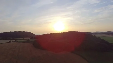 Low Sun Over Ocean Aerial Footage Tracking Shot of Sun in a Field and Woodlan Stock Footage 118369855