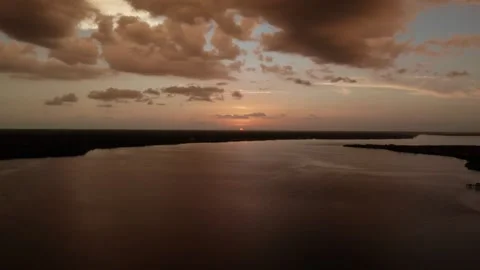 Low Sun Touching Flat Horizon Over Quiet El Jobean Bay Stock Footage 341132048
