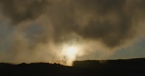 Low sun under dark steam clouds geothermal lava landscape Gunnuhver Iceland Stock Footage 220268305