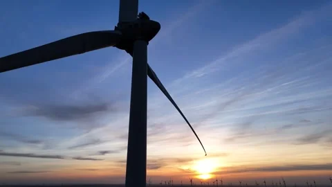 Low sunset perspective with turbine dominating the frame Stock Footage 331213539