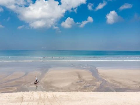 Low Tide Beach in Bali, Indonesia. Badung City. Ocean Water and Tourists in.. Stock Photos