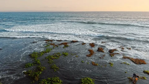 Low tide condition at Echo Beach, Bali, Indonesia. Local people looking for c Stockbeeldmateriaal 97488290