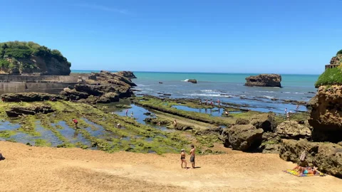 Low tide view of the Port des Pecheurs beach with tourists in Biarritz Stock Footage 340151513