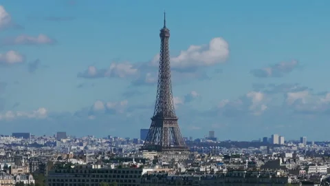 Low tight aerial shot of the Eiffel tower and surrounding buildings on a Stock Footage 291621938