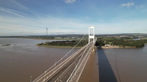 Low traffic on large road bridge spanning wide river Video stock 166660498