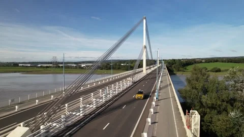 Low traffic passing cable-stayed bridge spanning river Stock-Footage 166661096