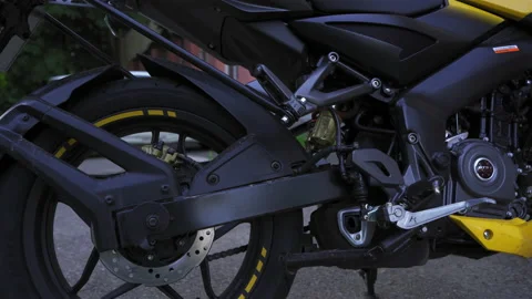 Low view camera slide Bajaj NS200 Pulsar motorcycle back wheel with engine as Vídeo Stock 134262033