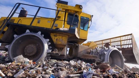 A low view on a landfill compactor on the move. Enviromet pollution concept. Stock Footage 81247094