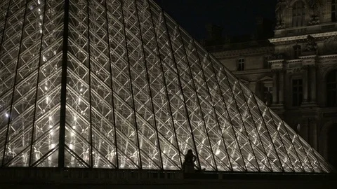 Low view of Le Louvre Pyramid lights at night - silhouette of people Paris Stock-Footage 94061907