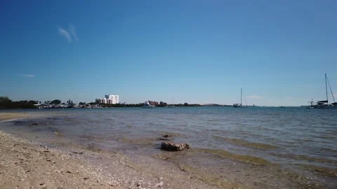 Low view over sand  rock and beach at Maximo Park in St Petersburg Florida towar Stock Footage 265716603