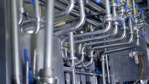 A low view on a piping system with blue valves. Video stock 79219672