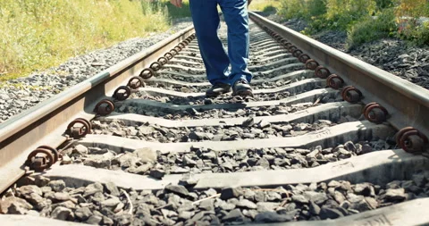 Low view of railroader with tablet walking on the railway 스톡 동영상 134919196