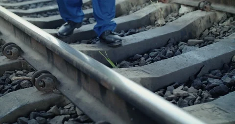 Low view of railroader's hand checks the rails serviceability with hammer Stock Footage 135570331