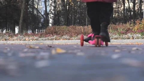 Low view of scooter moving by child legs Stock Footage 163830174