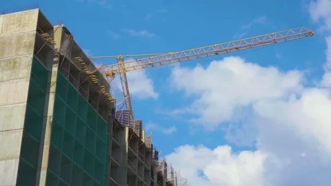 Low view of the self-erection tall tower crane near the concrete building. Stock Footage 110605107