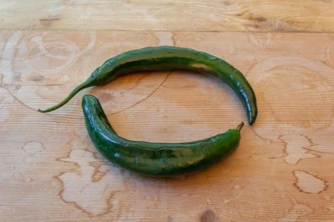 Low view of two Chilaca peppers forming a circle, centered, copy space Stock Photos