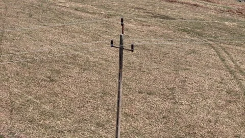 Low voltage concrete pole inspected from drone on wooded mountain slope sho.. Video stock 334034027