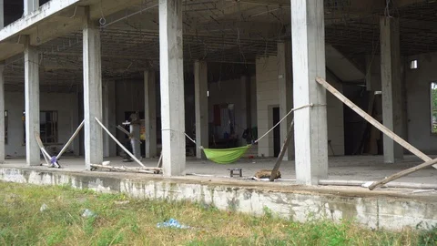 Low Wage Slave Labor in Construction - Hamock at Large Scale Construction Site Stock Footage 128656981