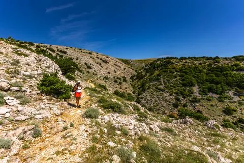 Low walls made of stone built by locals on the trail leading from Baska to .. Stock Photos