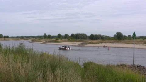 Low water level river Ijssel, yacht passing by - The Netherlands - Summer 2022 Stock Footage 202641883
