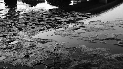Low Water Riverbed Exposed Rocks Black and White, Moody Slow Motion Cinematic Stock Footage 326225395