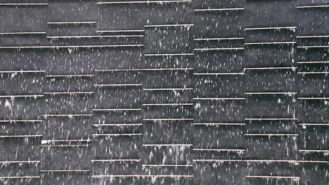 A low waterfall flowing through black stone slabs. For background or texture. Stock Footage 155239430