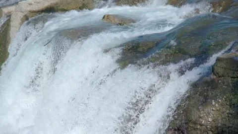 A low waterfall with flowing water Stock Footage 288454130