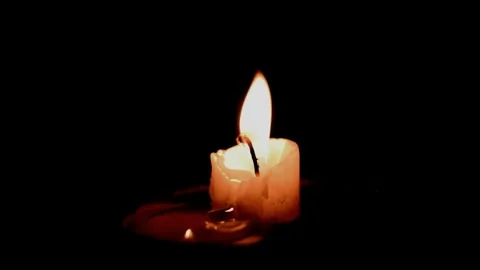Low white candle burning Stock Footage 246748356