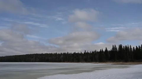 Low white clouds are moving above a frozen lake  Stock Footage 152169234