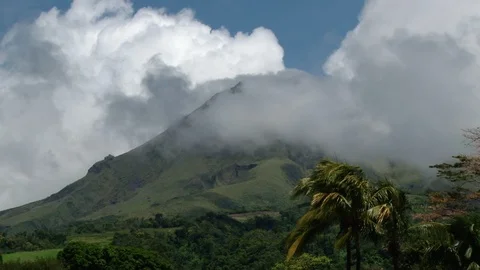 Low white clouds covering Mount Pelee at Martinique island Stock Footage 88033065