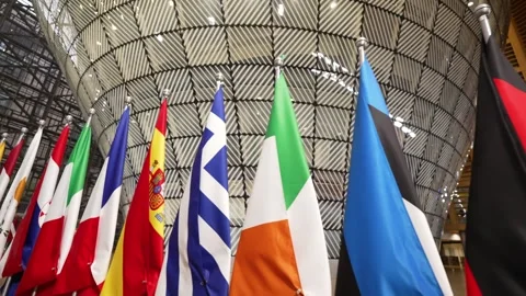 Low wide angle following EU flags inside the European Council building in Stock Footage 324891712
