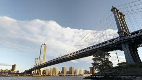 Low wide angle Manhattan Bridge crossing East River towards FDR drive, morning Stock Footage 99095007