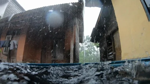 Low wide angle shot of gutter leaking water in heavy rain, Bali Stock Footage 140304033