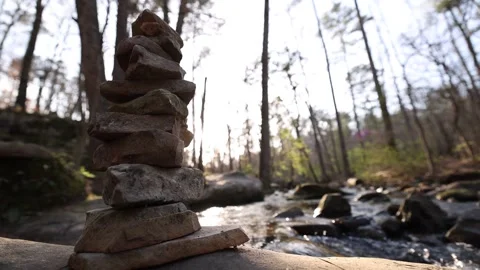 Low Wide Angle View Of Stacked Rocks Near Flowing River Stock-Footage 315225342