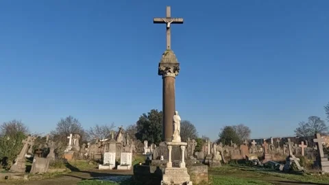 Low Wide Long Angle Shot of Tall Cross in Cemetery. Stock Footage 300060340