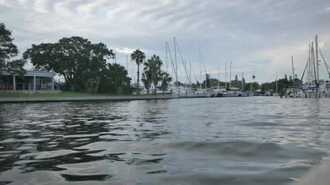 Low wide view from seawall looking back into Gulfport Marina with many boats in Stock Footage 284049641