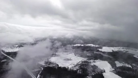 Low Winter Clouds Rolling Over Snowy Rural Farmland, Drone Flyover Video stock 337538297