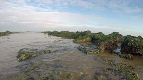 Lowangle timelapse of waves on blocks of a wavebreaker Stock Footage 298199308