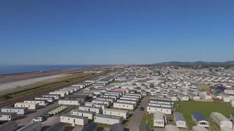 Lower altitude drone view over caravan park near city Stock Footage 313453212