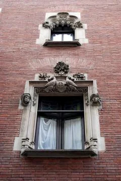 Lower angle of beautiful window with ornaments of old house Stock Photos