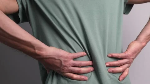 Lower back pain. Man hands holding painful spot closeup. Sedentary lifestyle Stock Footage 185115453
