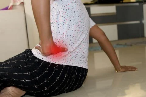Lower back pain relief techniques at home Stock Photos