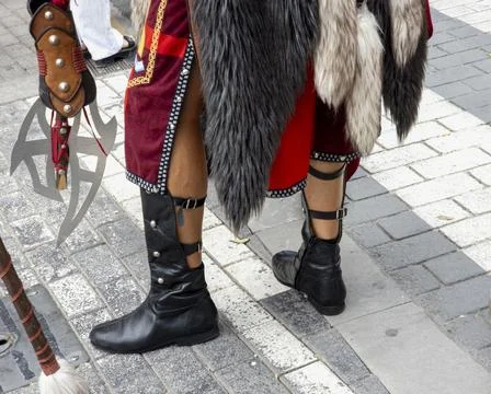 Lower body view of a medieval warrior costume with black leather boots and .. Stock Photos