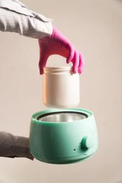 Lower can of sugar paste to heat vertical Stock Photos