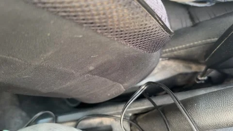 Lower car seat moves during adjustment beside the center console and cable, Stock Footage 337115160