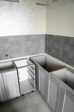 Lower custom kitchen cabinets installation with a furniture facades mdf. Gray Stock Photos