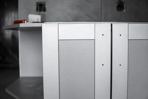 Lower custom kitchen cabinets installation with a furniture facades mdf. Gray Stock Photos
