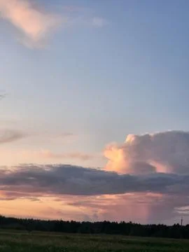 Lower deck of evening sky with illuminated pink cloud horizontal view Stock Photos
