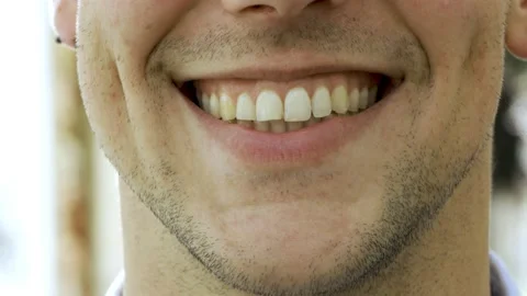 Lower face of young Caucasian man smiling at camera Stock Footage 132936088